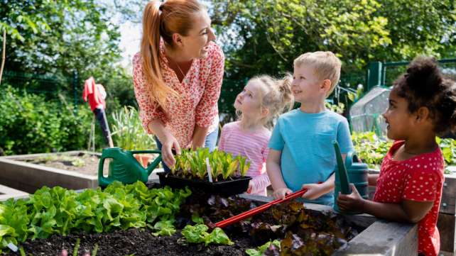 children planting with teacher